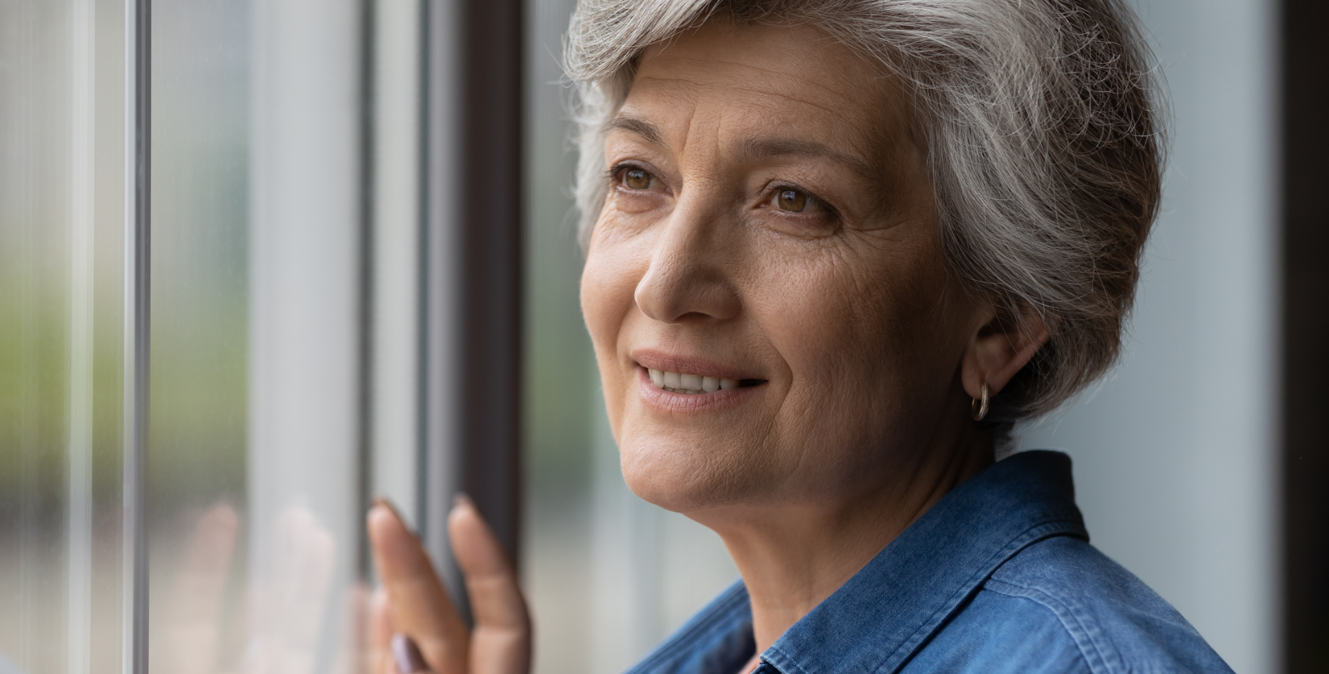 Woman looking out window and smiling